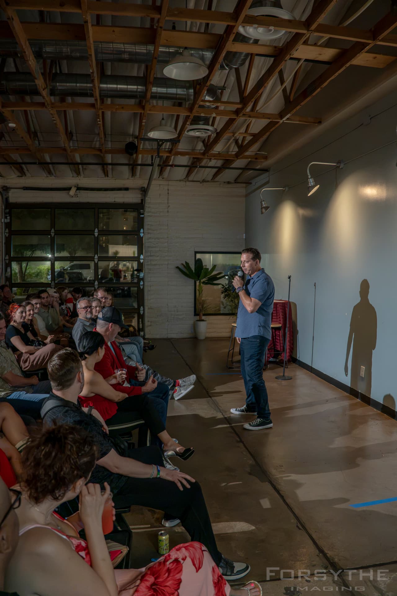 Comedian on stage in the brewery room at Arizona After Dark